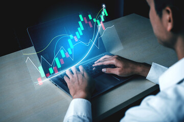 A focused professional analyzes real-time financial data on a sleek laptop, utilizing advanced...