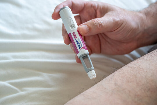 Man Administering Wegovy Injection for Weight Loss Treatment