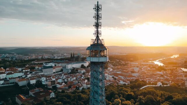 Experience the breathtaking sunrise over Prague as seen from the Petrin Lookout Tower. The city awakens with stunning views of gardens, buildings, and vibrant landscapes.