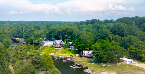 Aerial View of Riverside Homes and Forest Landscape in Norton Shores, Muskegon, Michigan”