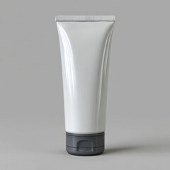 A clean white plastic squeeze tube with a dark gray cap for cosmetic or medical products isolated on white background