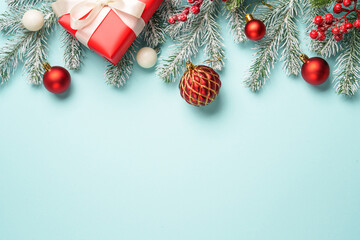 Christmas present with decor on blue with space for design.