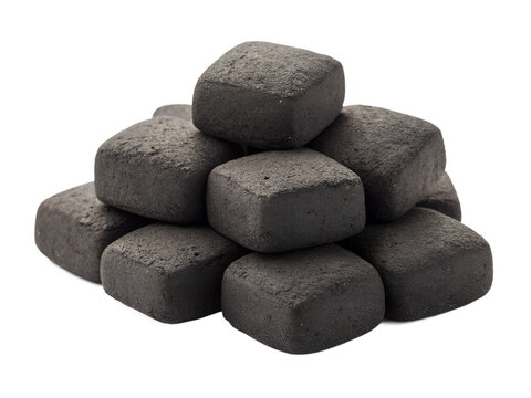 Dark square charcoal briquettes are stacked neatly in a small pile on a transparent background, isolated as a clean PNG image for various uses. - Powered by Adobe