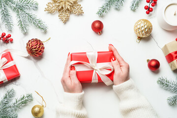 Christmas present and decorations on white.