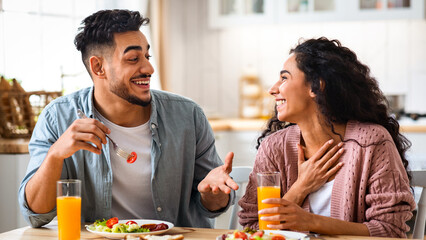 Domestic Life Of Young Couple. Middle Eastern Lovers Having Breakfast In Kitchen, Cheerful Young...
