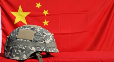 Military helmet in camouflage pattern against a red national flag background. Army concept for defense and protection.