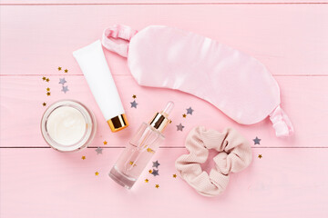 Sleeping mask with accessories on wooden background, top view. Sleeping routine concept