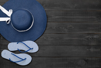 Blue beach accessories on wooden background, top view. Copy space for text