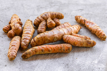 Fresh and Ground Turmeric on Rustic Background – Natural Health and Culinary Ingredient