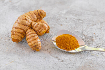 Turmeric root and powder on a rustic background, healthy food