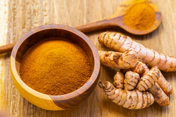 Fresh and Ground Turmeric on Rustic Background &ndash; Natural Health and Culinary Ingredient