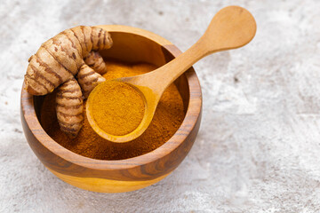 Fresh and Ground Turmeric on Rustic Background &ndash; Natural Health and Culinary Ingredient