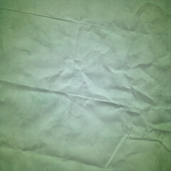 Green crumpled paper texture with soft wrinkles and subtle shading, ideal for eco-themed design, scrapbooking, posters, stationery, and creative textured backgrounds.