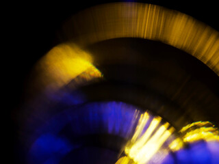 Abstract bokeh scene. Golden and blue glowing light leaks on black color background for design....