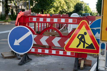 Construction barriers on a city street indicating lane usage and ongoing road work
