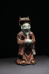 Red glazed figurine of an old man