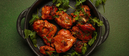 Top view of tandoori chicken, an Indian dish of roasted marinated chicken chunks in spiced curry...