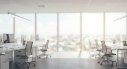 Blurred modern office interior with large windows and bright daylight. Abstract business background concept.