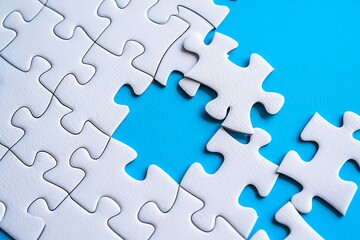 A partially completed white jigsaw puzzle with a missing piece against a vibrant blue background representing a challenge or a solution