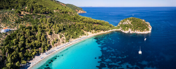 Best beaches of Greece. Sporades. Beautiful Skopelos island - Stafilos (Staphylos) with turquoise crystal sea surrounded by green hills. aerial drone panorama