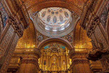 Dome and altar with golden interior of the Compania de Jesus (Society of Jesus) church in baroque style, Quito, Ecuador.