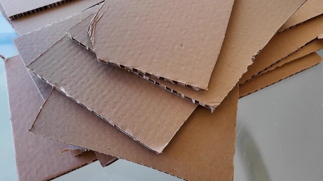 A pile of cut pieces of brown corrugated cardboard