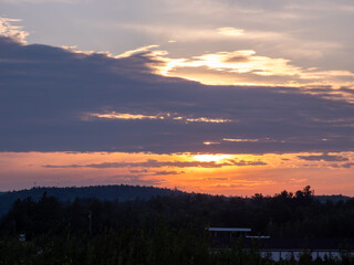 A cloudy sunset over the countryside during summer