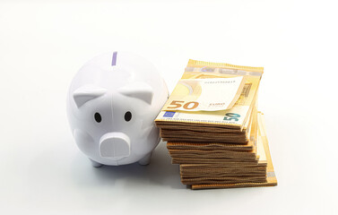 Piggy bank next to a bundle of 50 euro bills.