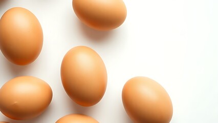 Fresh brown eggs arranged neatly on a pristine white surface, highlighting natural textures.