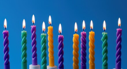 Vibrant Hanukkah Candles: Spiraling Flames Against a Bold Blue Backdrop