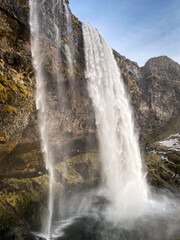 Scenic view of Seljalandsfoss waterfall in southern Iceland on a sunny spring day against blue sky