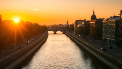 Obraz premium Golden sunset reflecting on a calm urban canal, creating a serene cityscape.