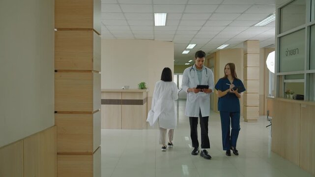 Doctors and nurses walk in the hallway of a hospital.