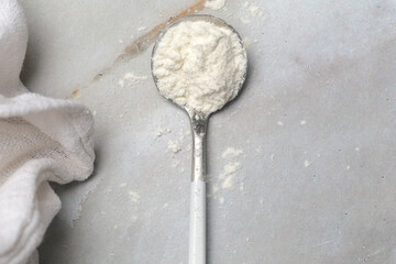 White powder in the spoon. Collagen protein powder or wheat flour. Concept of nutritional supplement, dieting, detox, preventive healthcare and healthy lifestyle.	
