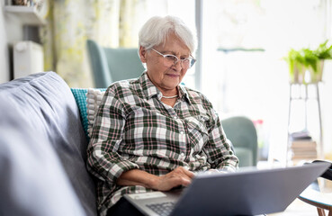 Senior woman using laptop at home

