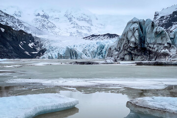 Scenic view of Svínafellsjökull Glacier, Iceland with dramatic blue ice formations and crevasses...