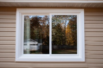 Autumnal woods reflected in new home window