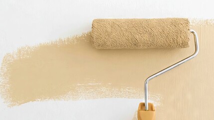 Obraz premium Paint roller with textured cover rests on a freshly painted wall, showcasing a smooth beige color, highlighting the home improvement process and creative interior design possibilities
