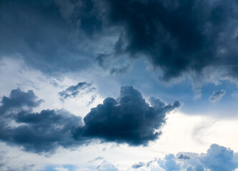 Dark blue rainy sky, clouds, stormy sky, dark blue sky. Cloudy sky with a hurricane in the clouds.