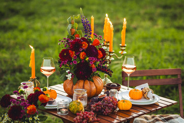 Beautiful elegant autumn table setting for thanksgiving family dinner or wedding. Orange pumpkin...
