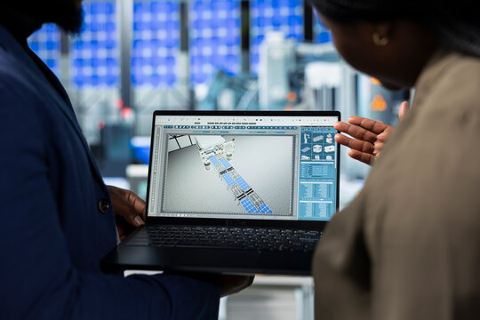 African American team of analysts collaborating in a solar tech factory, demonstrating inclusive teamwork and innovation for the production process. Industrial manufacturing at a plant.