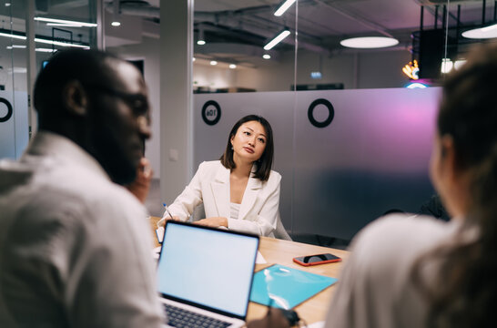 Diverse colleagues sharing laughs and celebrating in open office lounge, expressing joy and camaraderie, showcasing vibrant company culture and inclusive environment in tech-driven workplace