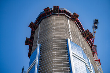 View of skyscraper construction in downtown area.