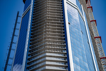 View of skyscraper construction in downtown area.