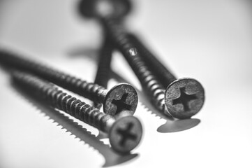 five screws lie on the white table top