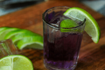 summer cocktail with lime garnish and ice