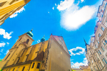Vibrant view of historic architecture with tall gothic towers, red rooftops, ornate facades and...