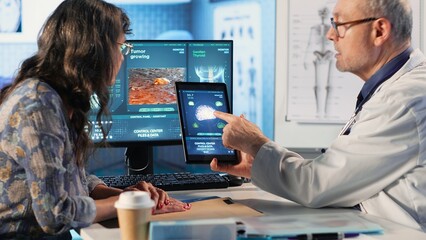 Meeting between doctor and patient to examine MRI scan showing a tumor, exploring treatment...