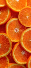 Slices of vibrant, juicy orange fruit filling the frame with bright, textured detail
