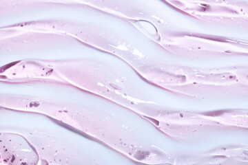 Cream gel drops red transparent cosmetic sample texture with bubbles on pink background